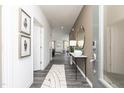 Inviting entryway with gray flooring, console table and decorative mirror at 218 Macon Lake Drive # 43, Apex, NC 27523
