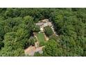 An aerial view of a secluded estate with a manicured lawn, mature trees, and a private setting at 2283 Mays Chapel Rd, Sanford, NC 27330