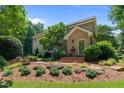 Charming home featuring brick steps, a classic front door, and attractive landscaping with mature shrubbery at 2283 Mays Chapel Rd, Sanford, NC 27330
