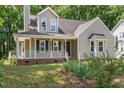Charming two-story home with a cozy front porch and well-maintained landscaping, enhancing its curb appeal at 2324 Dahlgreen Rd, Raleigh, NC 27615
