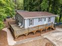 A quaint home with a wooden deck, pale blue siding, and neat landscaping at 2704 Shaftsbury St, Durham, NC 27704