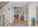 Inviting foyer with hardwood floors, staircase, and open view to the living area, perfect for greeting guests at 3104 Whitehart Ln, Apex, NC 27539