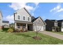 Charming two-story home with gray siding, brick accents, and a well-manicured lawn at 32 Iroquois Ct, Garner, NC 27529
