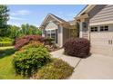 Beautiful home with well-maintained front yard landscaping, featuring a variety of colorful plants and bushes at 323 Rosedale Creek Dr, Durham, NC 27703