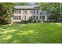 Attractive two-story home with dark shutters, well-kept lawn, and professional landscaping at 3412 Paddock Cir, Raleigh, NC 27613