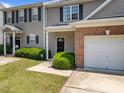 A beautiful townhouse with a garage, an inviting front entrance and a well-manicured lawn at 3526 Londonville Ln, Raleigh, NC 27604