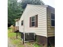 Exterior view of a house showing light siding, brown accents, and outdoor utilities at 4112 Forrest Ave, Efland, NC 27243