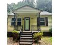 Charming home exterior with welcoming front porch and classic design elements at 4112 Forrest Ave, Efland, NC 27243