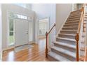 Welcoming entryway with hardwood floors, staircase, and large windows providing ample natural light at 4305 Heathgate Ln, Raleigh, NC 27613
