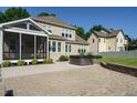 Spacious backyard with patio, hot tub, screened porch, and manicured landscaping at 5305 Yorkville Ct, Holly Springs, NC 27540