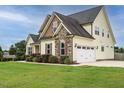 Lovely home featuring a two-car garage and nicely landscaped grounds at 5400 Falconton Ln, Raleigh, NC 27610