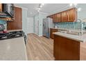 Well-equipped kitchen with stainless steel appliances, wood cabinetry, and ample counter space at 5561 Roan Mountain Pl, Raleigh, NC 27613