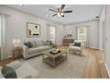 Inviting living room with a neutral color palette, plush seating, and lots of natural light at 5561 Roan Mountain Pl, Raleigh, NC 27613