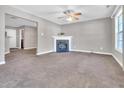 Cozy living room featuring a fireplace, neutral walls and ample natural light at 5617 Tealbrook Dr, Raleigh, NC 27610