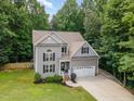 Beautiful aerial view of a well-maintained home with lush greenery and a spacious yard at 6717 Country Hollows Ln, Holly Springs, NC 27540