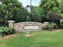 Stone sign marking the entrance to Vintage Pointe, surrounded by lush greenery and landscaping at 6717 Country Hollows Ln, Holly Springs, NC 27540