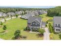 Aerial view of a two-story home with an attached garage and a well-maintained lawn in a residential neighborhood at 710 Legacy Falls S Dr, Chapel Hill, NC 27517