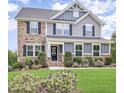 Attractive front entrance with a well-manicured lawn and tasteful landscaping at 710 Legacy Falls S Dr, Chapel Hill, NC 27517