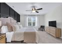 Serene main bedroom with a ceiling fan and natural light, offering a peaceful retreat at 717 Utley St, Holly Springs, NC 27540