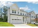 Attractive modern farmhouse with a two-car garage, green lawn, and covered front porch at 772 Mirkwood Ave, Apex, NC 27523