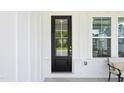 Inviting covered front porch featuring a modern front door and comfortable seating at 772 Mirkwood Ave, Apex, NC 27523