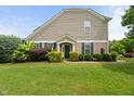Beautiful home featuring manicured lawn, tasteful landscaping, and a welcoming entrance with green shutters at 7873 Cape Charles Dr, Raleigh, NC 27617