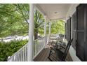 Relaxing porch with rocking chairs and white columns, providing a serene outdoor space at 804 Town Side Dr, Apex, NC 27502