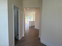 Hallway view of the kitchen featuring white cabinets and island at 88 Willow Cameron Way, Angier, NC 27501