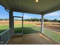 Screened-in back porch with white railings overlooking expansive lawn at 88 Willow Cameron Way, Angier, NC 27501