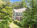 Aerial view of a well-maintained home with lush landscaping and mature trees at 8808 Colesbury Dr, Raleigh, NC 27615
