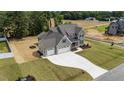 An aerial view showcases this home's three-car garage and generous lot size in a desirable neighborhood at 90 Lane Farms Way Way, Holly Springs, NC 27540