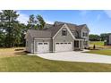 This well-maintained home features a spacious three-car garage and beautifully landscaped front yard at 90 Lane Farms Way Way, Holly Springs, NC 27540