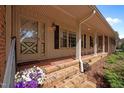 Inviting front porch with brick flooring and decorative details, creating a warm and welcoming entrance at 913 Milton Rd, Durham, NC 27712