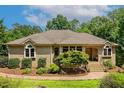Attractive brick home featuring manicured landscaping and inviting front entryway at 101 Cardiff Pl, Chapel Hill, NC 27516
