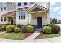 Close up of townhome with well-manicured landscaping and inviting entrance at 1019 Tranquil Crk Way, Wake Forest, NC 27587