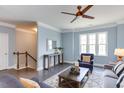 Bright and airy living room with hardwood floors, crown molding, and abundant natural light at 1019 Tranquil Crk Way, Wake Forest, NC 27587
