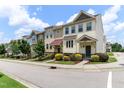 Street view of townhomes showcasing curb appeal with sidewalks and manicured lawns at 1019 Tranquil Crk Way, Wake Forest, NC 27587