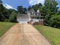 Charming two-story home with a covered front porch and a two-car garage at 109 Hidden Farm Ln, Holly Springs, NC 27540