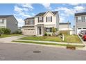 Two-story house boasting a two-car garage, complemented by a neat lawn and simple landscaping at 1204 Bridgewater Dr, Durham, NC 27704