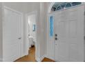 Bright foyer featuring hardwood floors, a half bath, and a view into the home at 12227 Orchardgrass Ln, Raleigh, NC 27614
