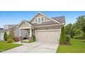 Beautiful home with a two-car garage, lush lawn, and professionally landscaped yard at 12309 Aberdeen Chase Way, Durham, NC 27703