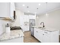 Bright kitchen with white cabinets, granite countertops, and stainless steel appliances at 12309 Aberdeen Chase Way, Durham, NC 27703