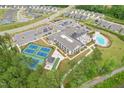 Aerial view showcases the community's amenities, tennis courts, pool, and clubhouse at 1625 Plover Cir, Fuquay Varina, NC 27526
