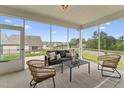 Relaxing screened patio with comfortable seating and scenic neighborhood views at 1625 Plover Cir, Fuquay Varina, NC 27526