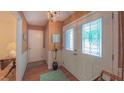 Inviting entryway shows the decorative front doors, adjacent closet and stylish furnishings at 1815 Hawthorne Ln, Burlington, NC 27215