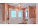 Welcoming entryway boasts decorative glass doors, stylish light fixture and elegant decor at 1815 Hawthorne Ln, Burlington, NC 27215
