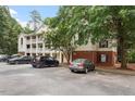Exterior building view showcasing the brick facade, parking and mature trees providing shade at 1851 Trailwood Heights Ln, Raleigh, NC 27603