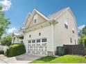 Side view of a two-story home with a two-car garage, manicured lawn, and a pristine driveway at 214 Ashdown Forest Ln, Cary, NC 27519