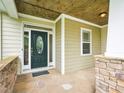 Inviting front door with decorative glass, sidelights, stone accents, and a 'Welcome' mat at 214 Ashdown Forest Ln, Cary, NC 27519