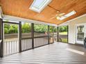 Covered screened porch with a wood ceiling, ceiling fan, and views of the backyard at 214 Ashdown Forest Ln, Cary, NC 27519